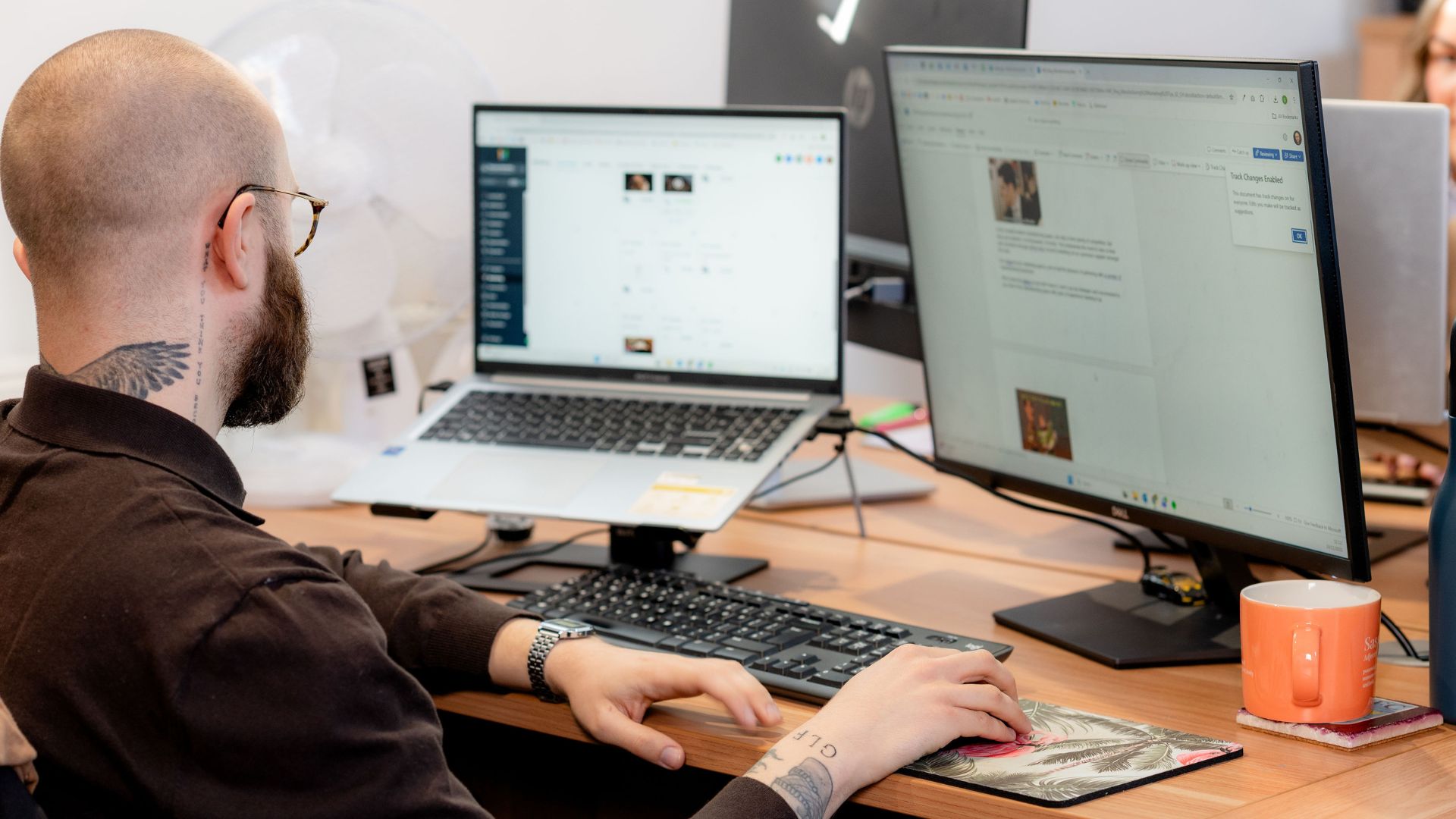 George sitting at his desk working at a computer.